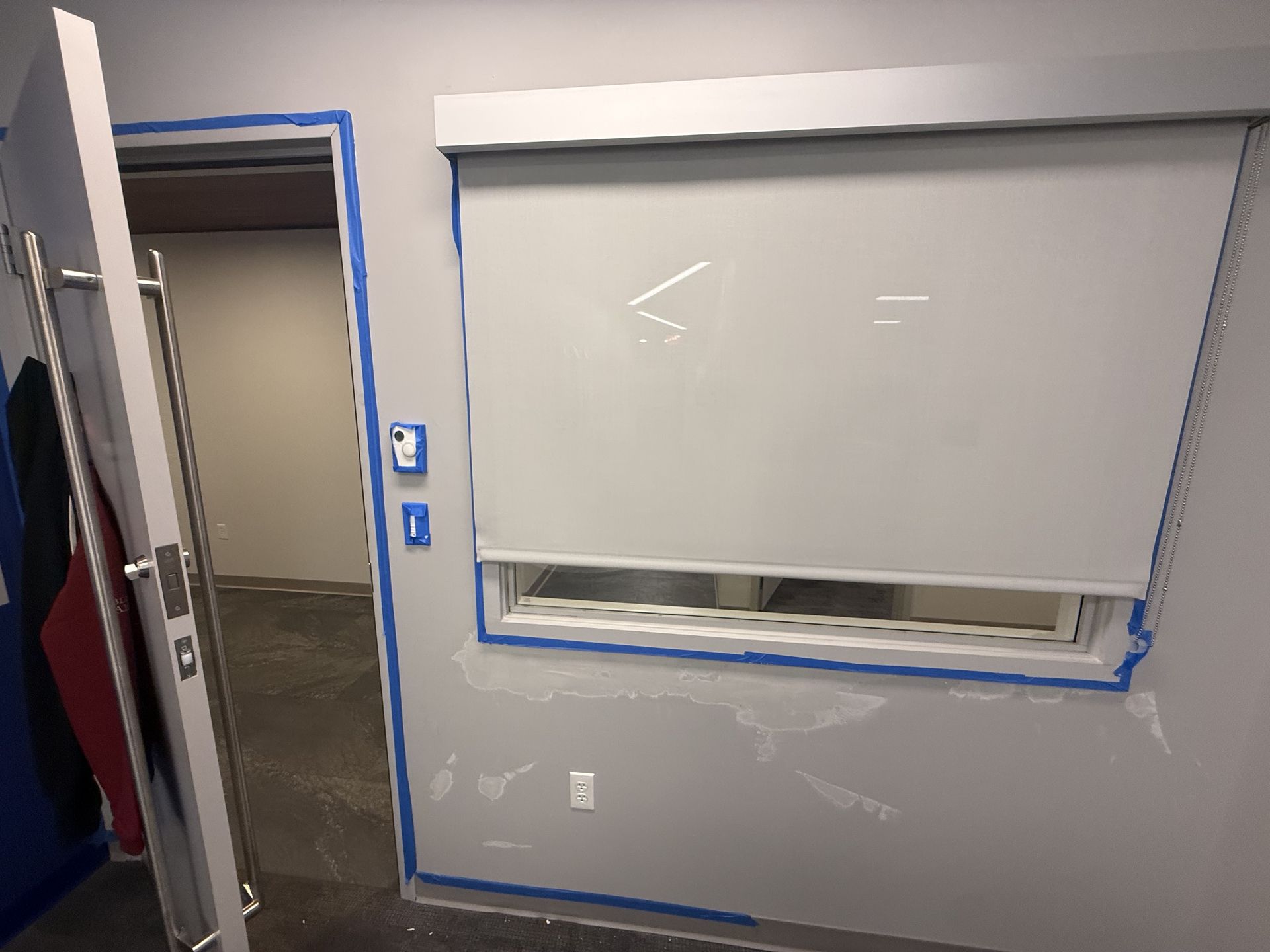Drywall patching and painting prep on a commercial wall