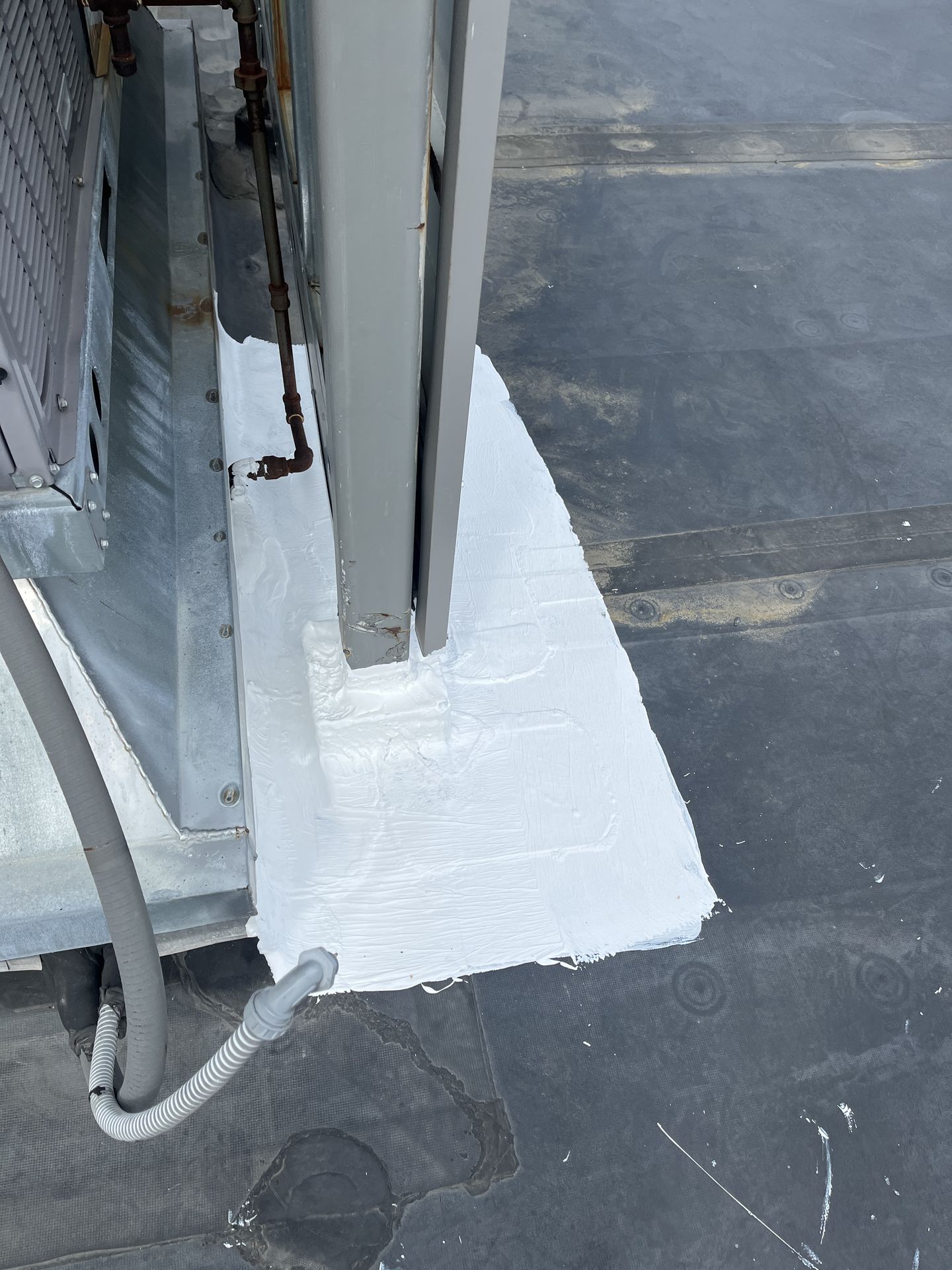 Rooftop HVAC curb sealing and maintenance on a commercial building